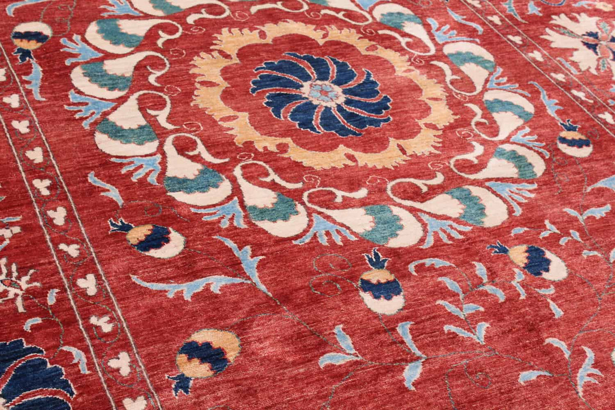 Close-up of the red Suzani wool rug with floral medallion, 318 × 264 cm, detail 9.