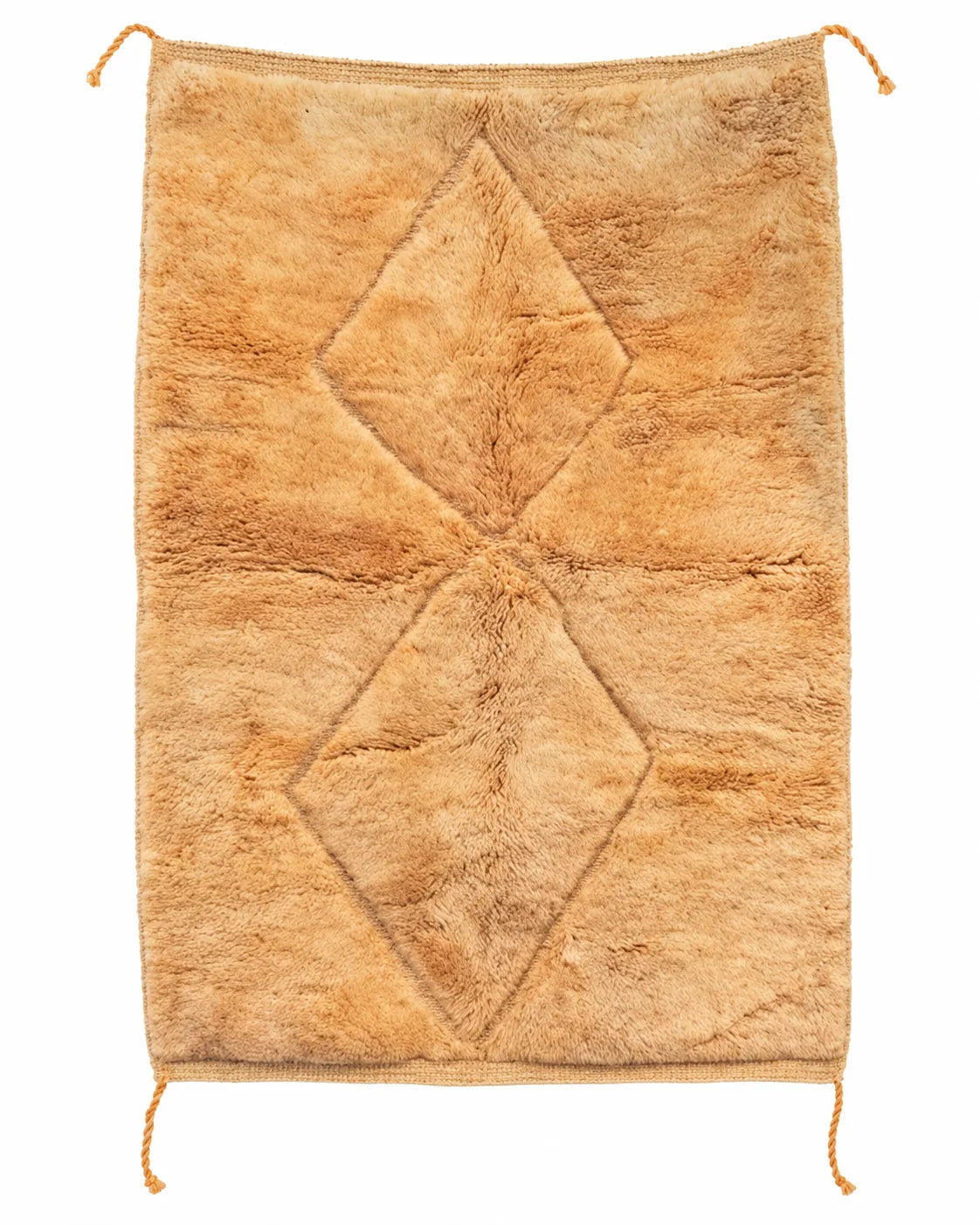 Beni Ourain wool rug, two subtly raised diamonds on a honey-colored wool ground in a bedroom setting