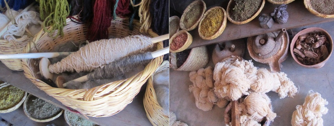 
Skeins of yarn and a basket of spindles beside bowls of colored materials.