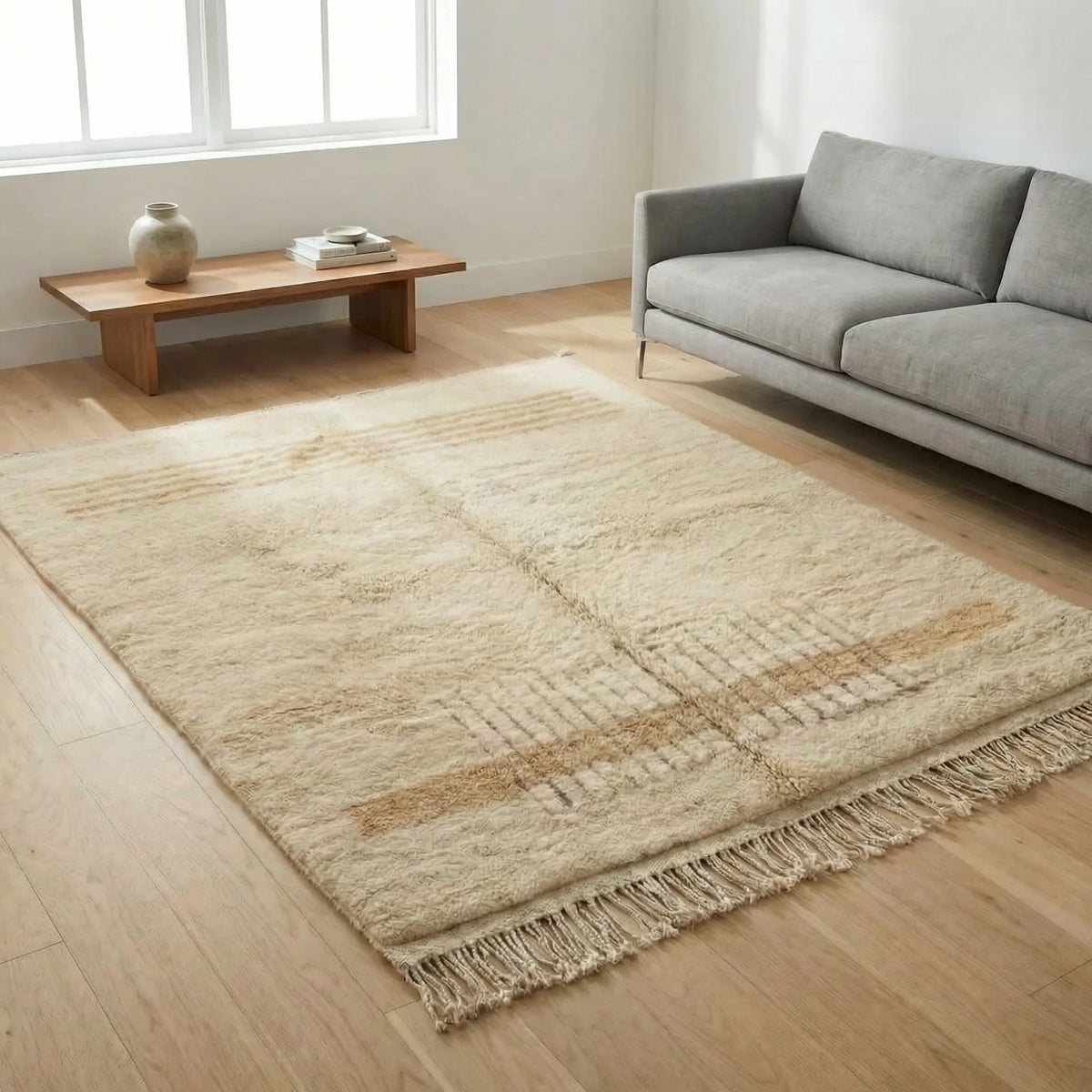 Beni Ourain wool rug, earth-tone horizontal stripes and a grid on natural white wool in a living room setting