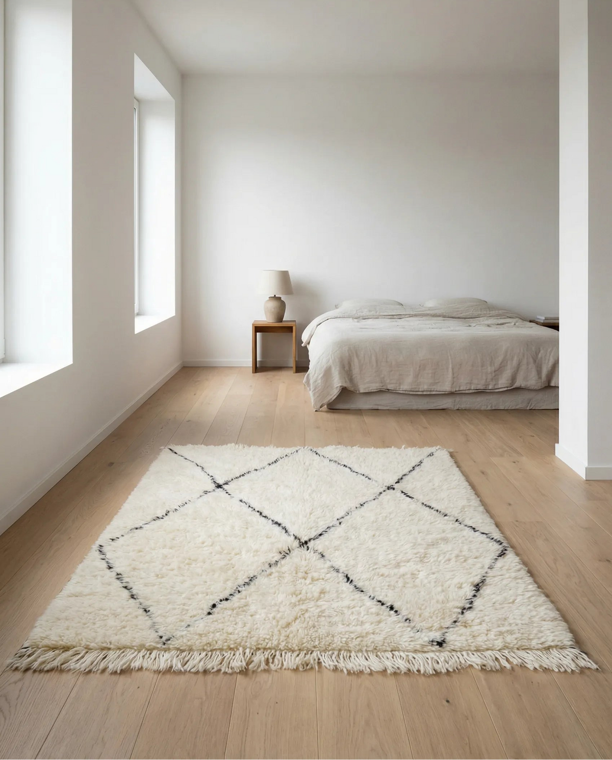 Beni Ourain wool rug, black diamond outlines on natural white high-pile wool in a bedroom setting
