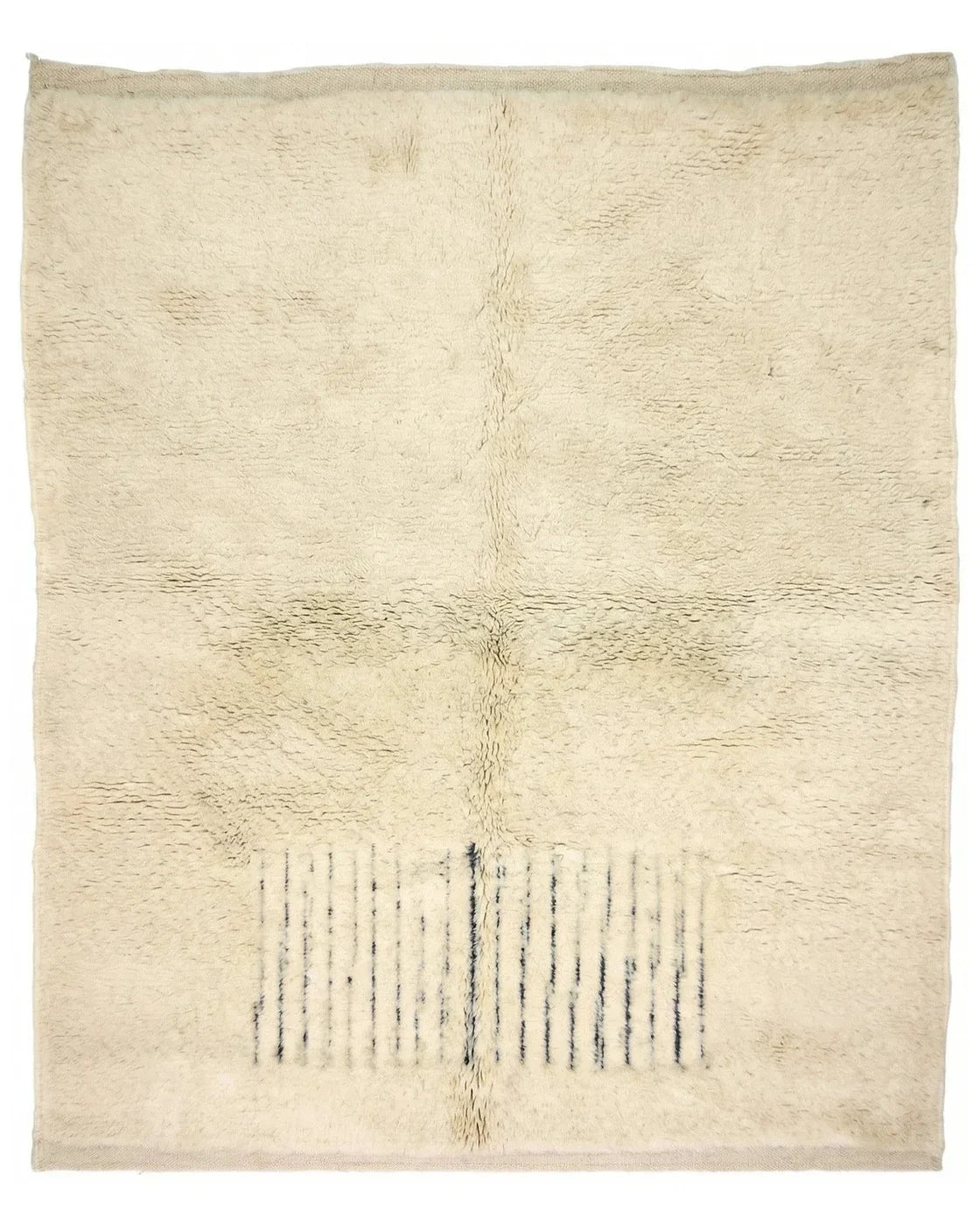 Moroccan wool rug, short dark blue lines near one end of a cream high-pile ground