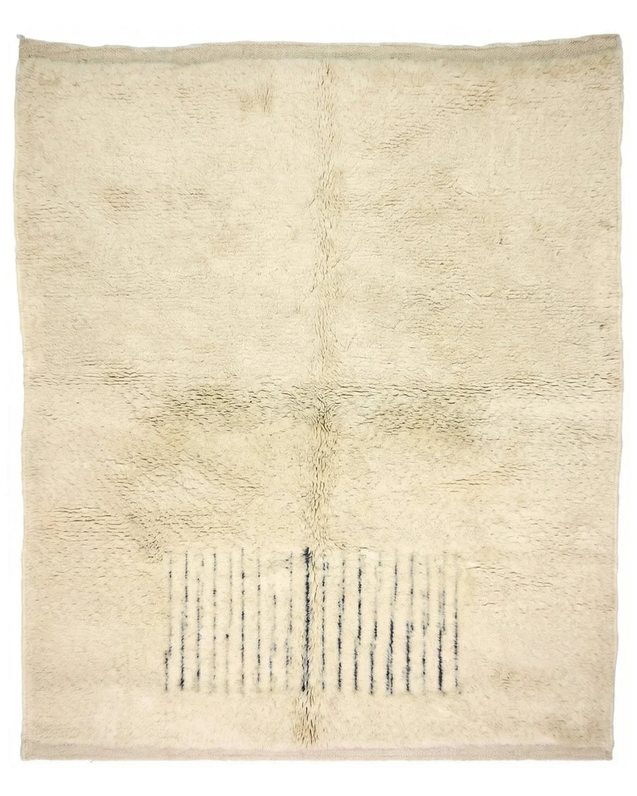 Moroccan wool rug, short dark blue lines near one end of a cream high-pile ground