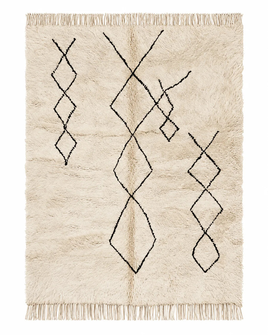 Front view of Moroccan wool rug, three offset chains of black diamonds on a cream wool ground
