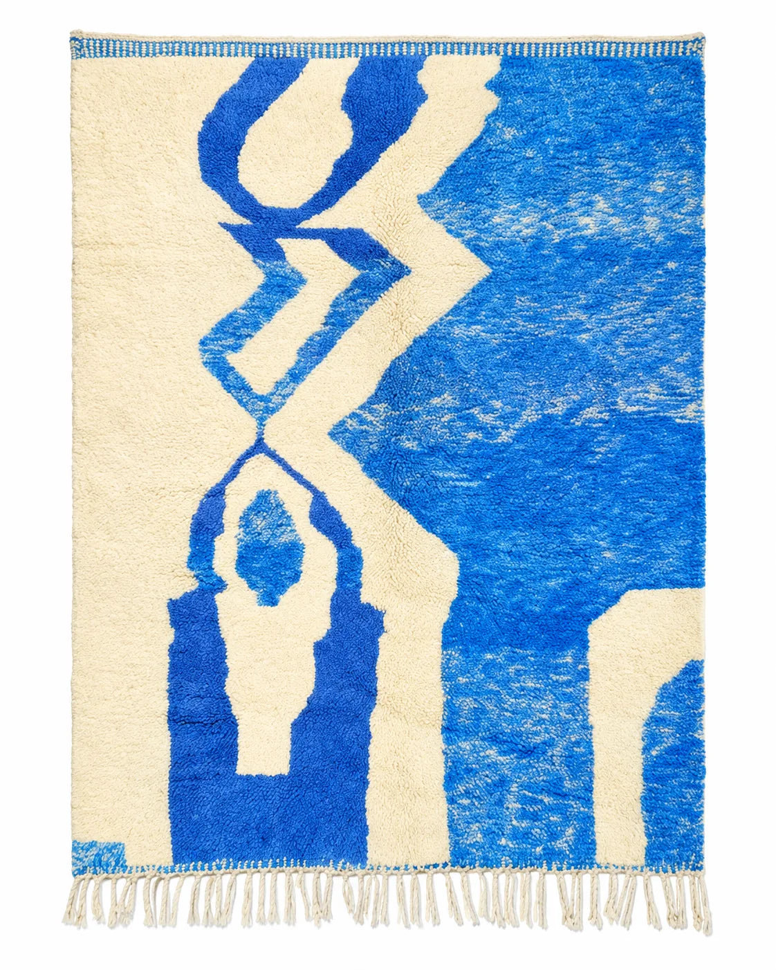 Azilal wool rug, broad cobalt blue geometric shapes against cream in a bedroom setting