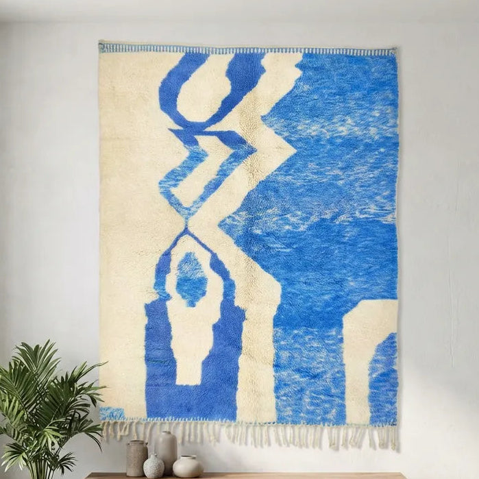 Azilal wool rug, broad cobalt blue geometric shapes against cream in a bedroom setting