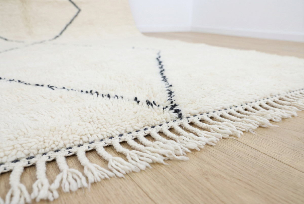 Detail of Beni Ourain wool rug, large open diamond shapes on a cream wool ground