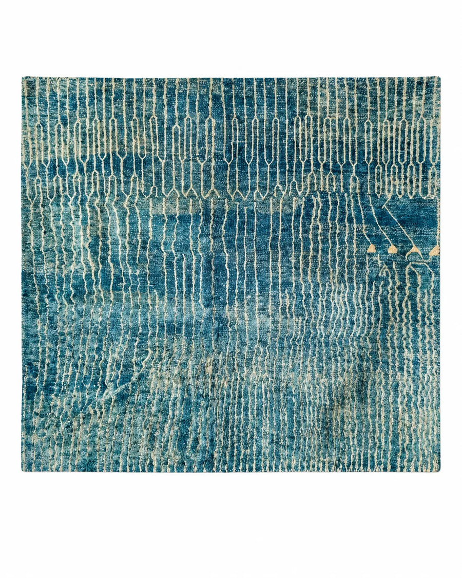 Beni Ourain wool rug, closely spaced natural white vertical lines on ocean blue wool in a living room setting
