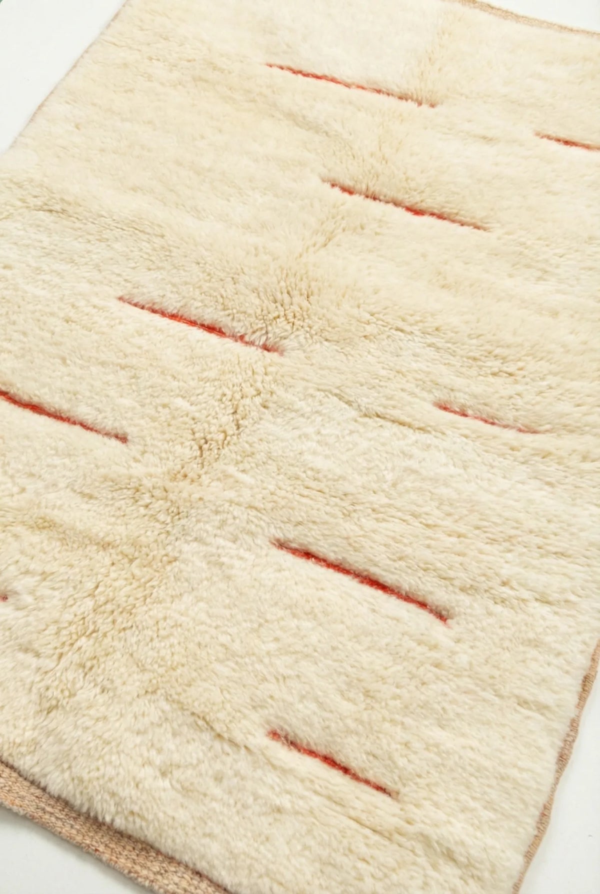 Beni Ourain wool rug, cream ground with short red horizontal lines, product view 3