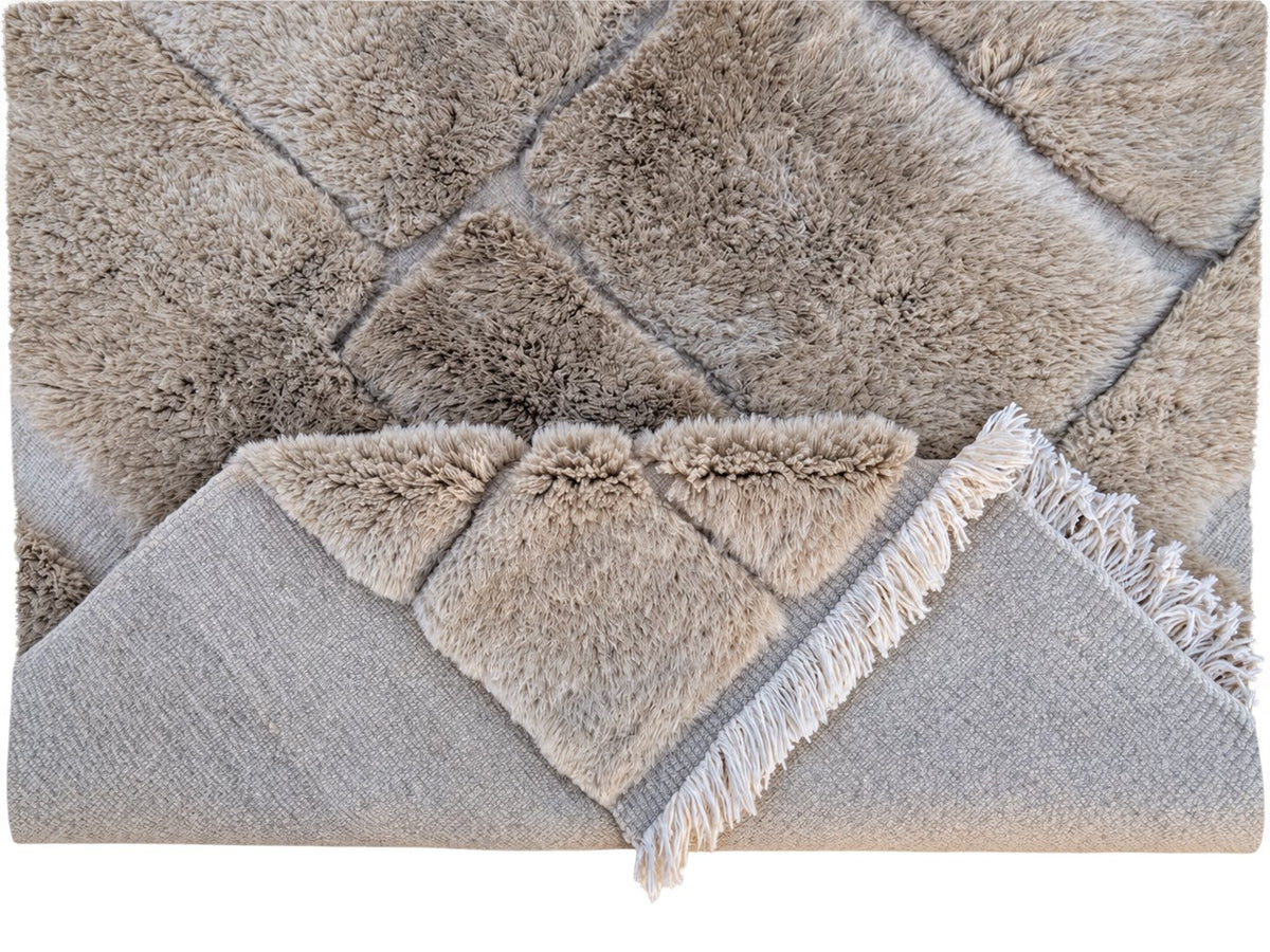 Detail of Taupe Beni Ourain Wool Rug with Block Relief, 370 × 283 cm.