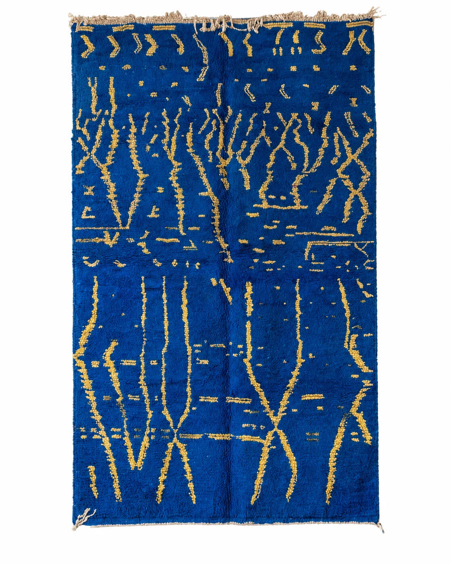 Front view of Moroccan wool rug, organic golden yellow lines on a deep blue wool ground