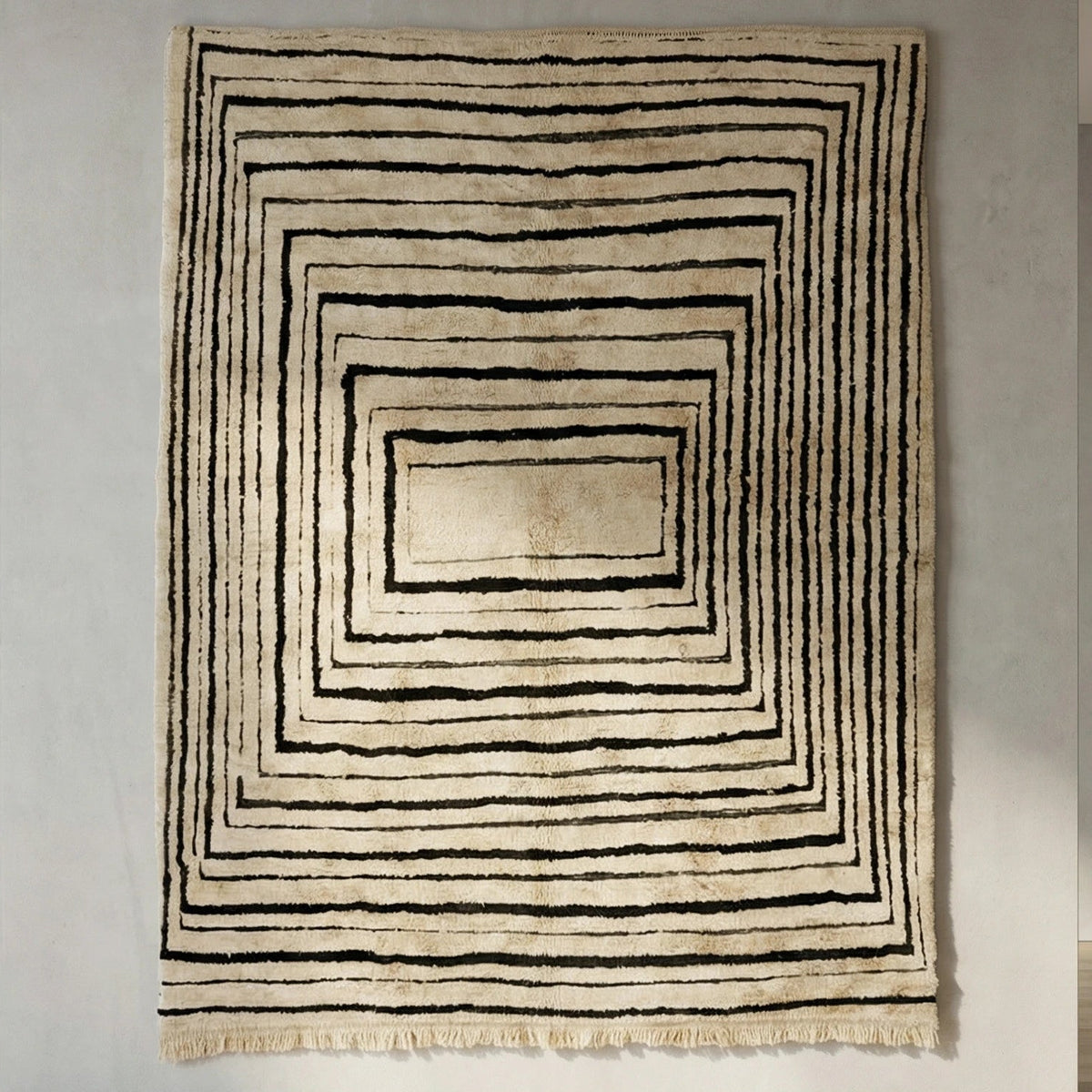 Front view of Beni Ourain wool rug, concentric black rectangles on a light wool ground