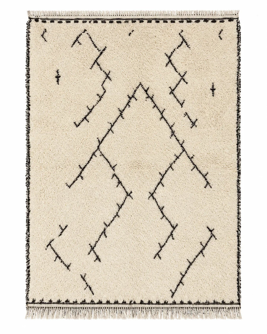 Front view of Beni Ourain wool rug, black arrow-like and branching symbols on a cream wool ground