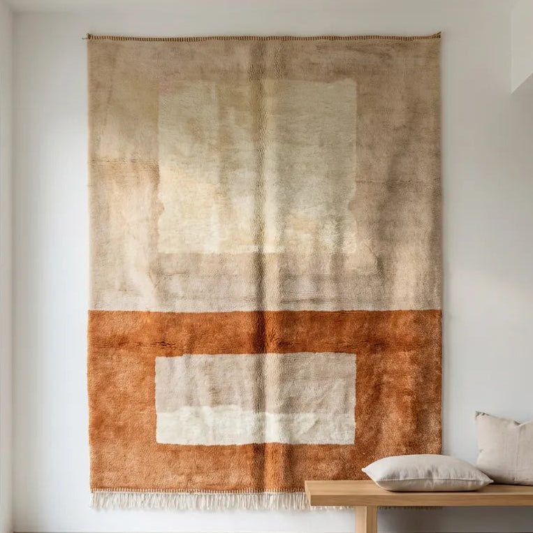Mrirt wool rug, interlocking geometric rectangles in sand and terracotta in a living room setting